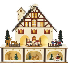 Dekorative Weihnachtshausbeleuchtung mit Figuren und Zügen