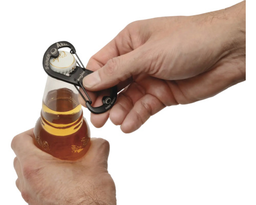 Eine Hand öffnet eine Flasche mit einem Karabinerhaken-Flaschenöffner.