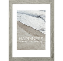 Gerahmtes Bild mit Strandmotiv und dem Spruch ''Happiness comes in waves''