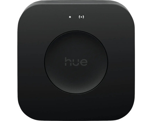 Philips Hue Bridge Smart Home Zentrale in Schwarz, quadratisch mit abgerundeten Ecken und zentraler Taste mit Philips Hue Logo.