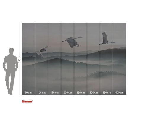 Fototapete mit Kranichen im Flug über eine bergige Landschaft